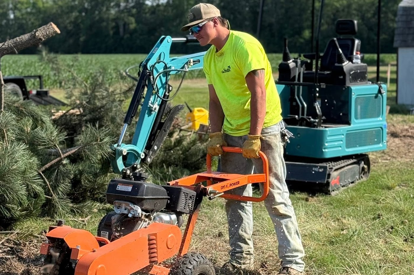 A 302 Tree Co technician operating a stump grinder on the job